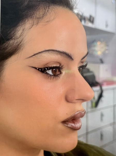 An image of a photo of Rosalia as Magick in Euphoria season 3 wearing pencilthin black brows crystalstudded liner and...